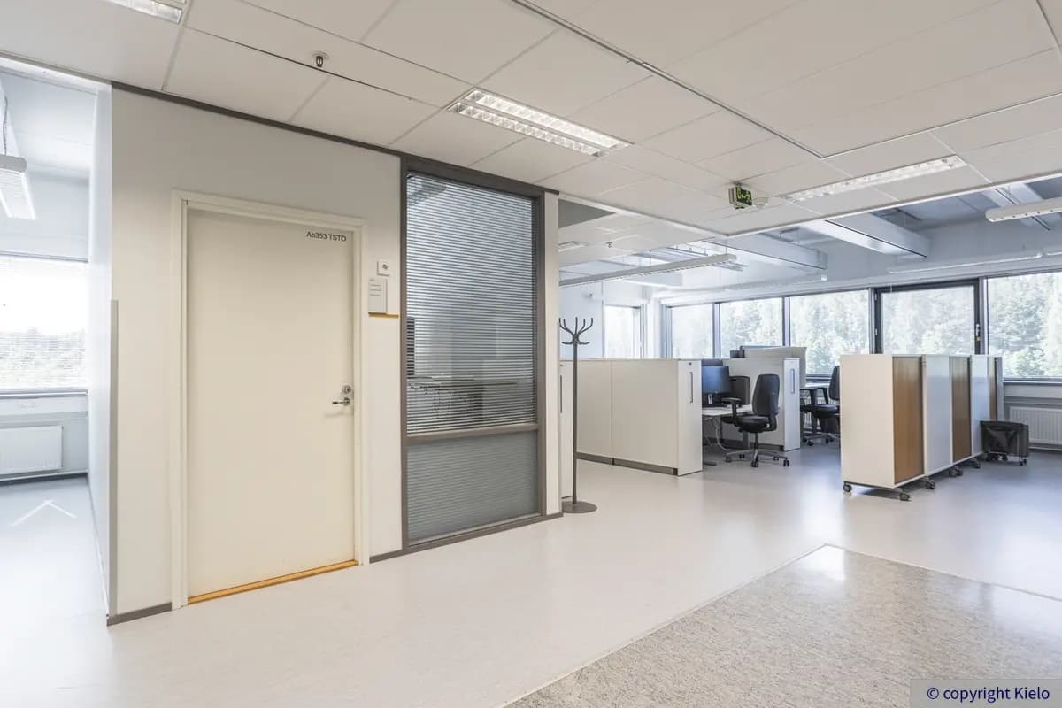 Jyväskylän Mattilanniemi 6-8 toimitilakiinteistön valoisan 3. kerroksen 1163 m2 toimitilan avotila ja pieni toimistohuone. Avotilassa hyllyillä jaettuja työpisteitä ja isot ikkunat.